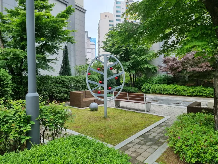 나무 모양 조형물과 벤치가 있는 쉼터