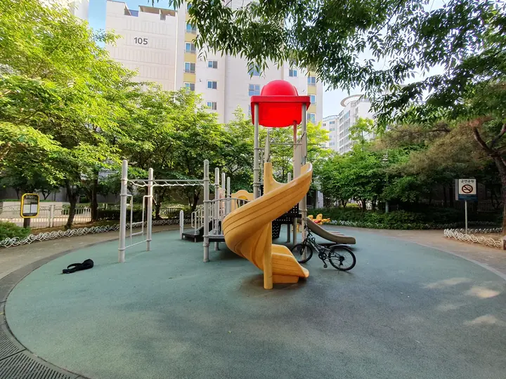 나무 그늘에 둘러싸인 놀이터